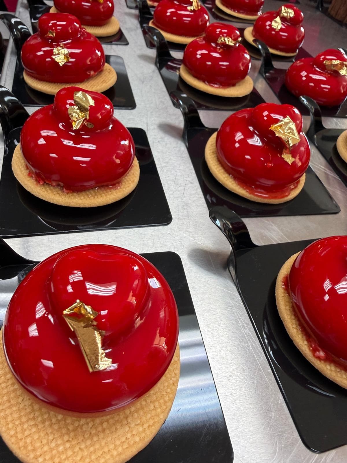 Heart-shaped dessert with red glaze and gold leaf