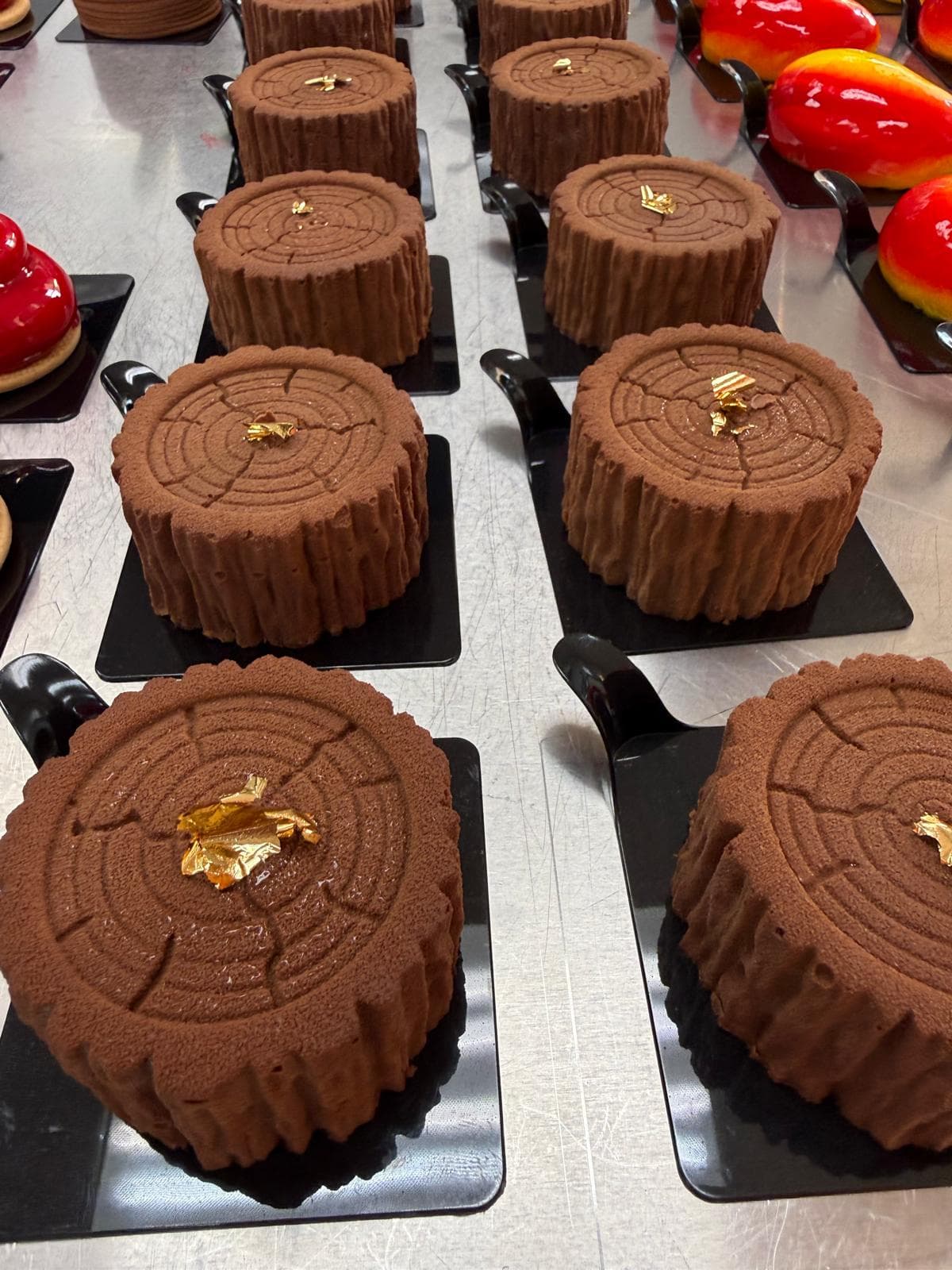 Log-shaped chocolate desserts with gold leaf